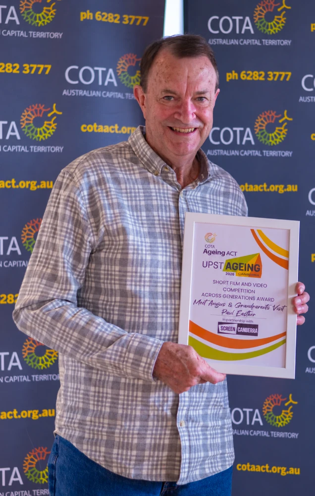 Paul Easther holding the Across Generations Award at the 2026 COTA ACT UpstAGEING competition