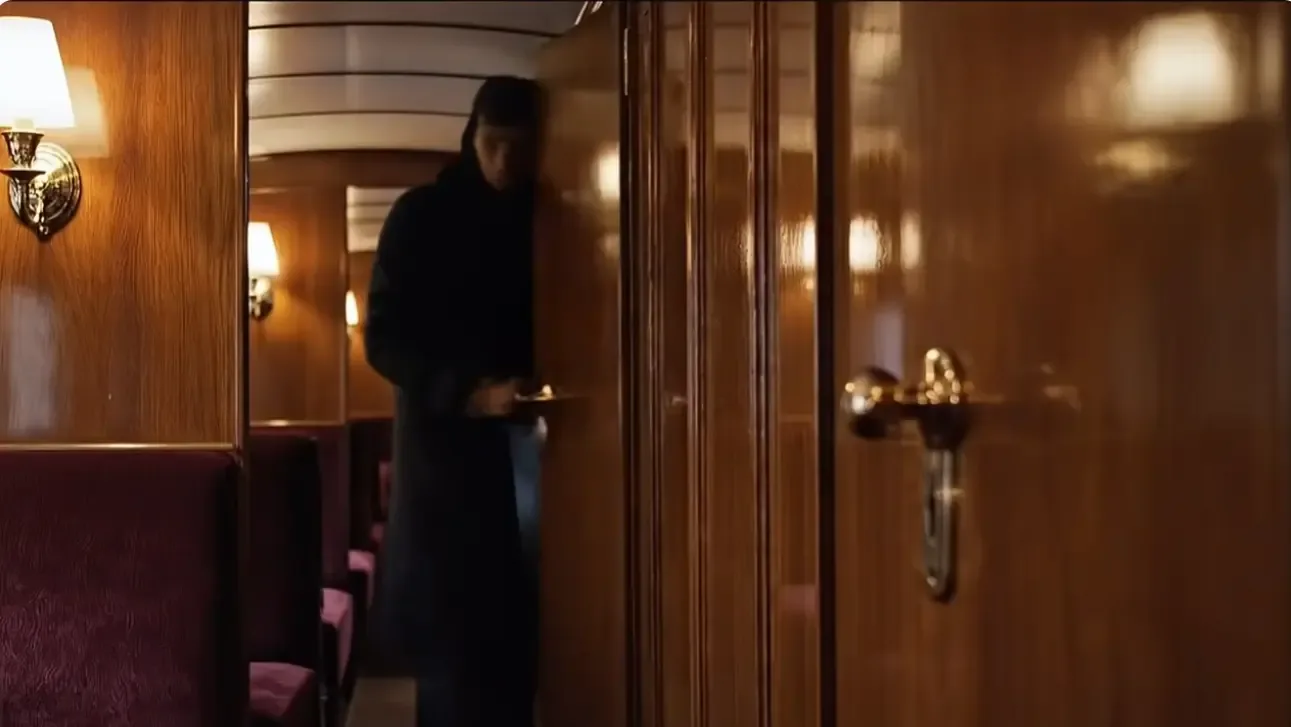 A shadowy figure moving through the corridor of the Orient Express